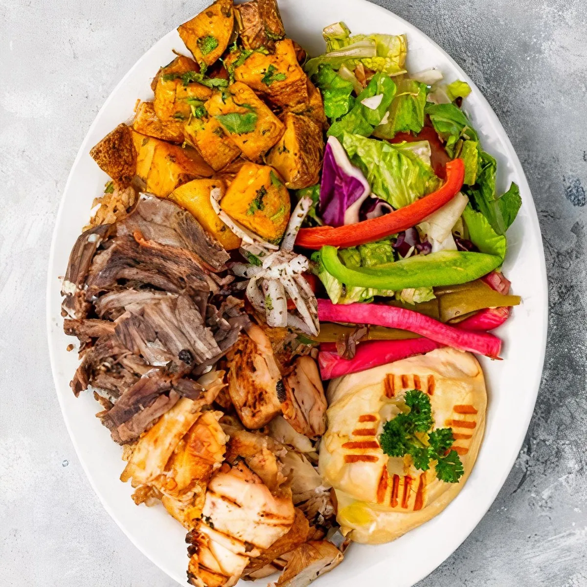 Mixed beef and chicken shawarma platter with potatoes and salad